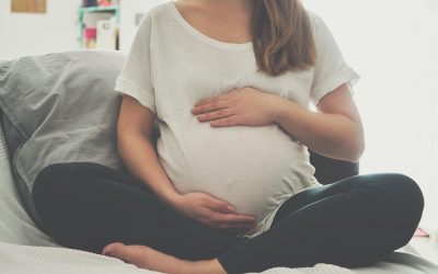 Pregnant woman touching her belly